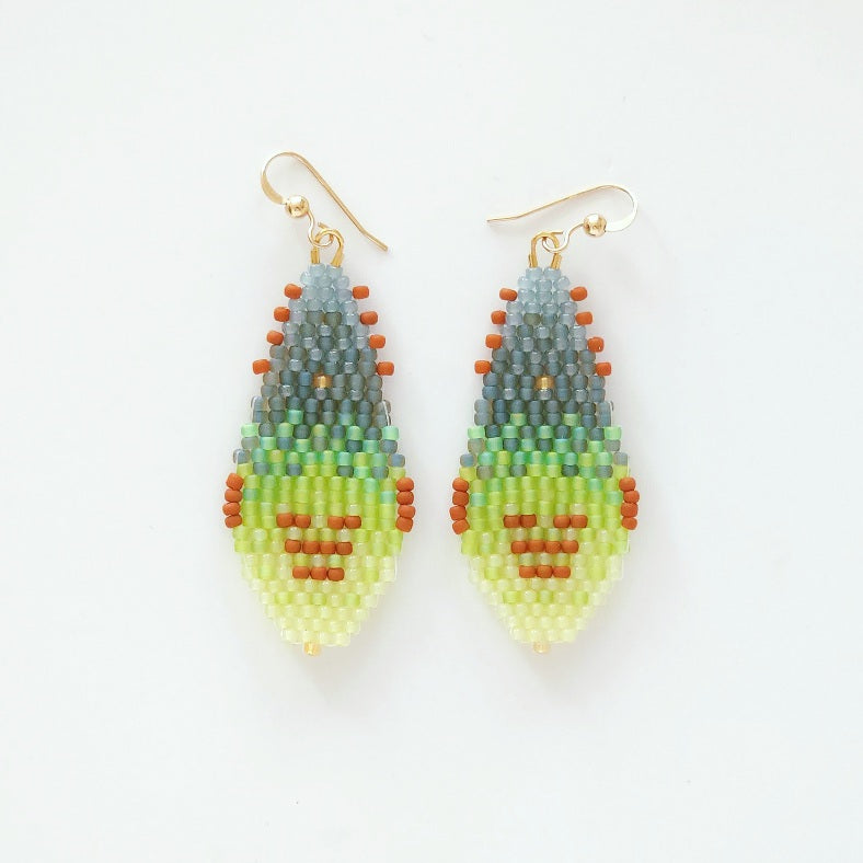Pair of beaded earrings with a gradient design on a white background