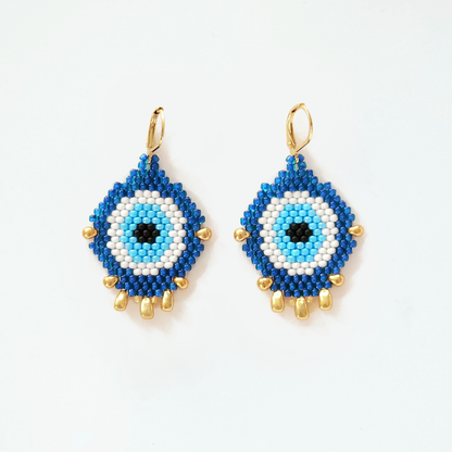 Blue and white beaded earrings with gold accents on a white background