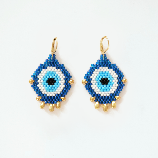 Blue and white beaded earrings with gold accents on a white background