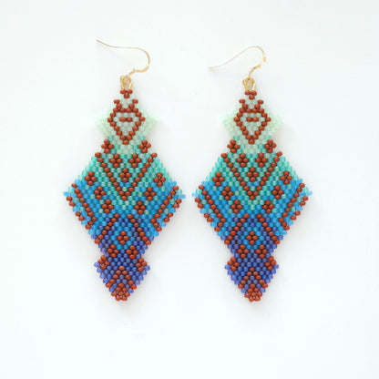 Pair of beaded earrings with geometric pattern on a white background