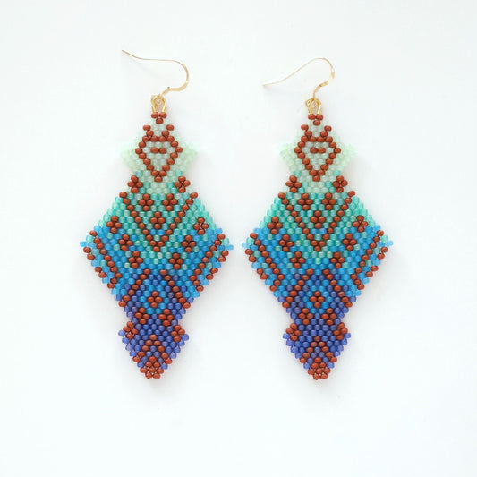 Pair of beaded earrings with geometric pattern on a white background
