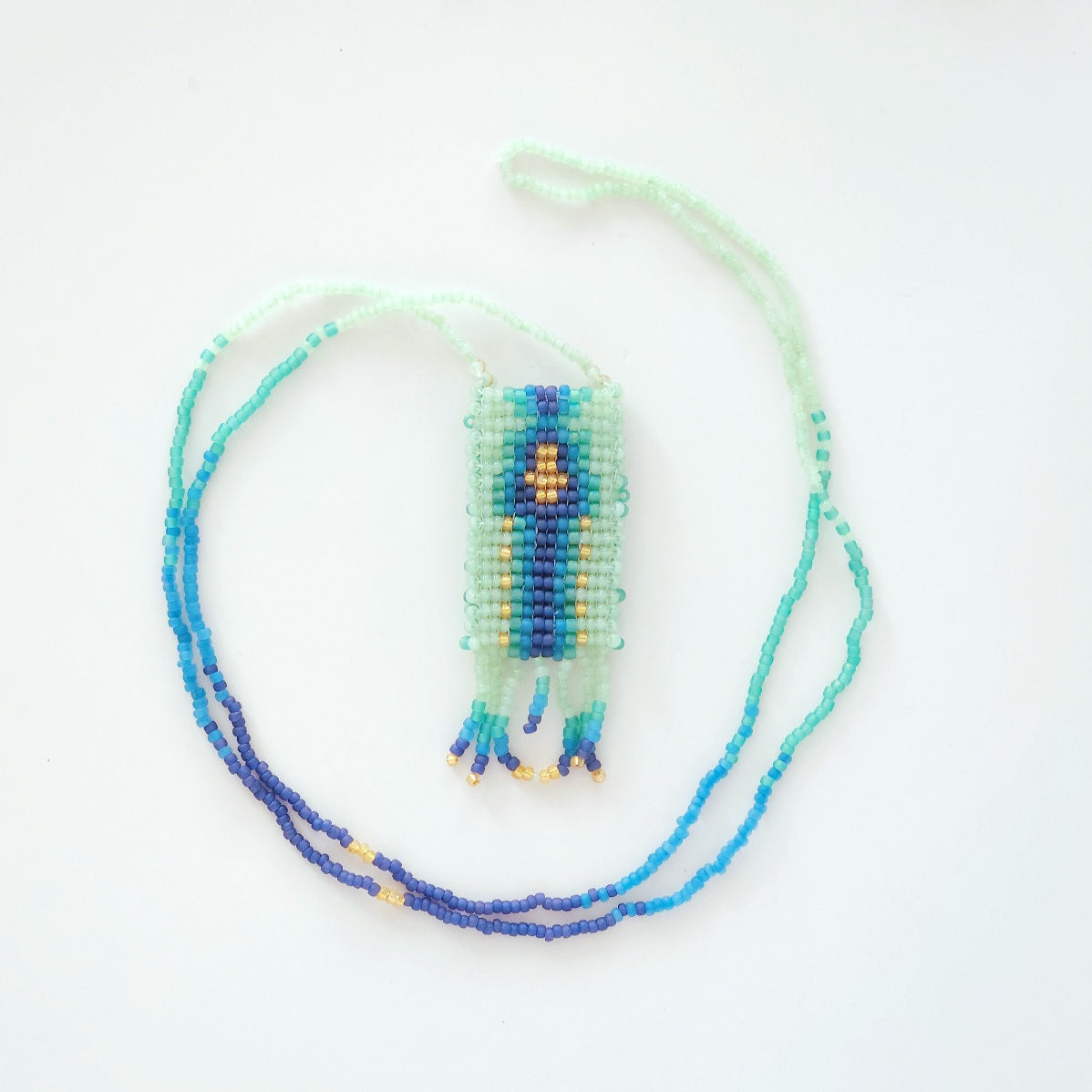 Beaded necklace with a decorative element on a white background