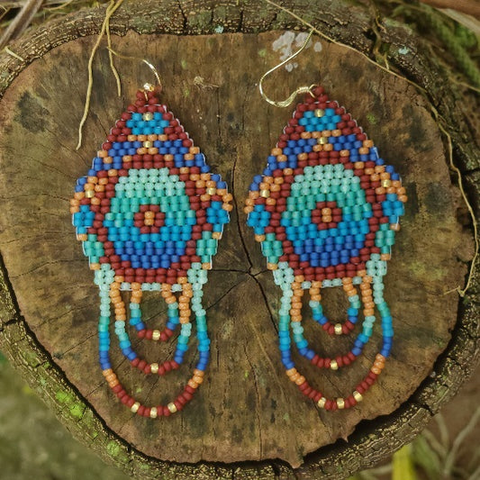 Colorful beaded earrings on a wooden surface