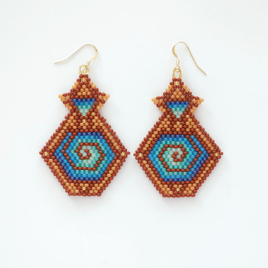 Pair of beaded earrings with geometric pattern on a white background