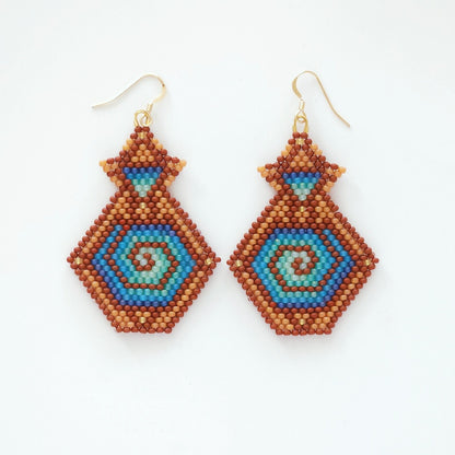 Pair of beaded earrings with geometric pattern on a white background