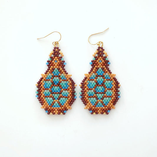 Pair of beaded turtle earrings on a white background