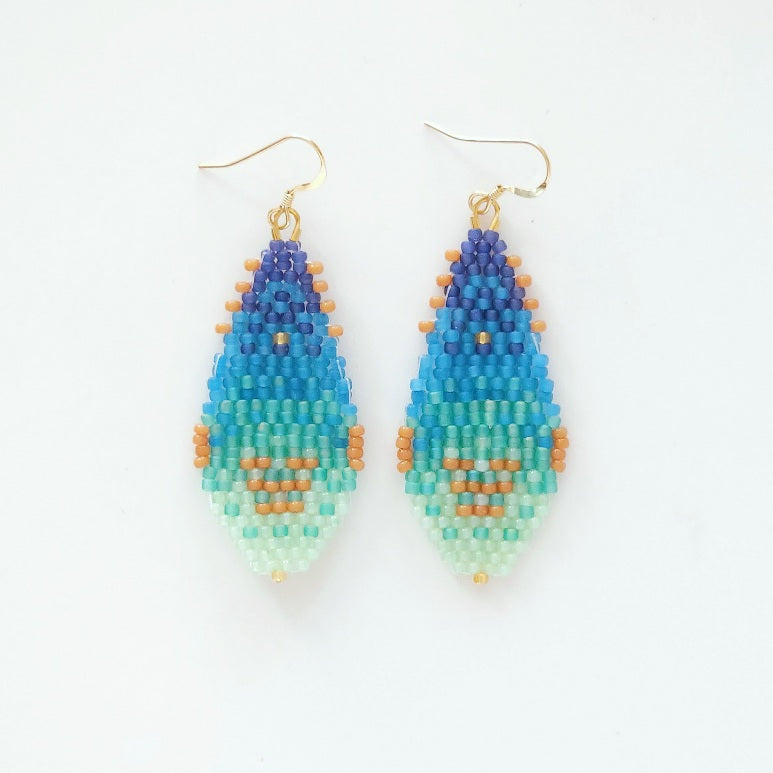 Pair of beaded earrings with blue, green, and orange gradient on a white background