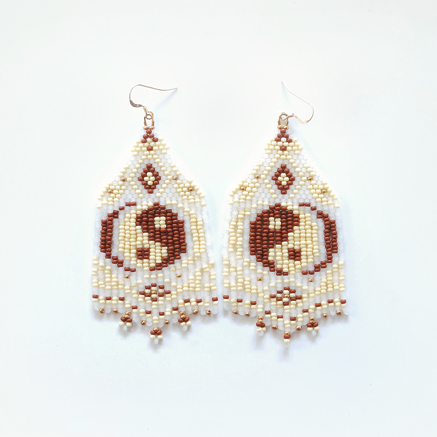 Pair of yin yang beaded earrings on a white background